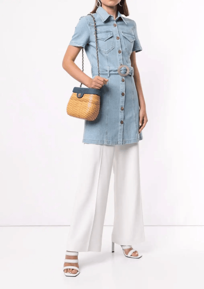 Model wearing Chanel denim and wicker bag