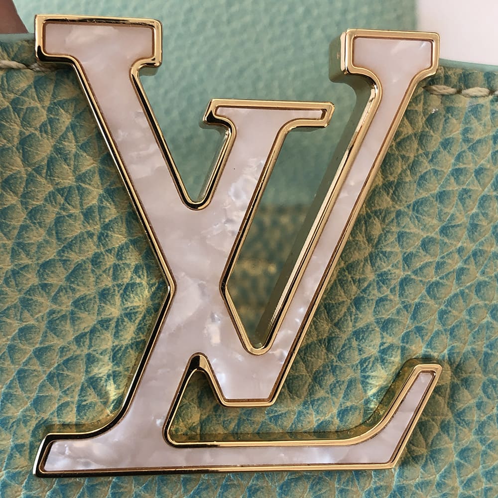 image of fake louis vuitton mother of pearl stone on a capucines bag by FASHIONPHILE